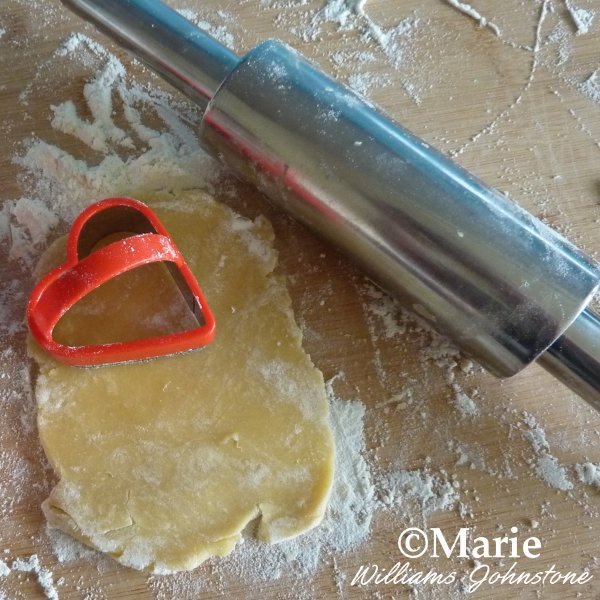 Cutting Out the Heart Shaped Cookies stainless steel rolling pin cookie dough red heart shaped cutter