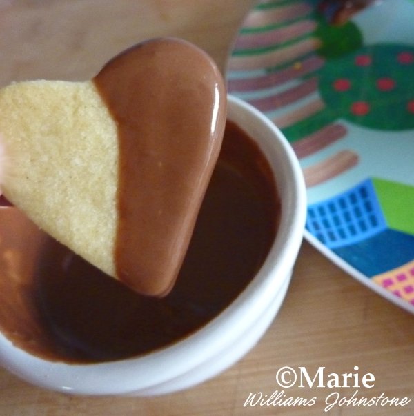Dipping the Heart Shaped Cookies into Melted Chocolate