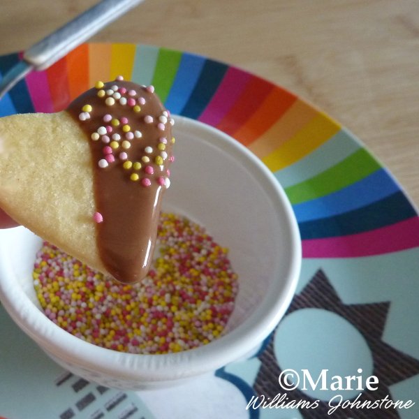 Adding Sprinkles to Your Heart Shaped Cookie after half dipping into chocolate