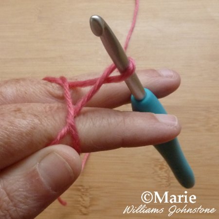 Looped yarn on crochet hook casting on crocheting beginner tutorial